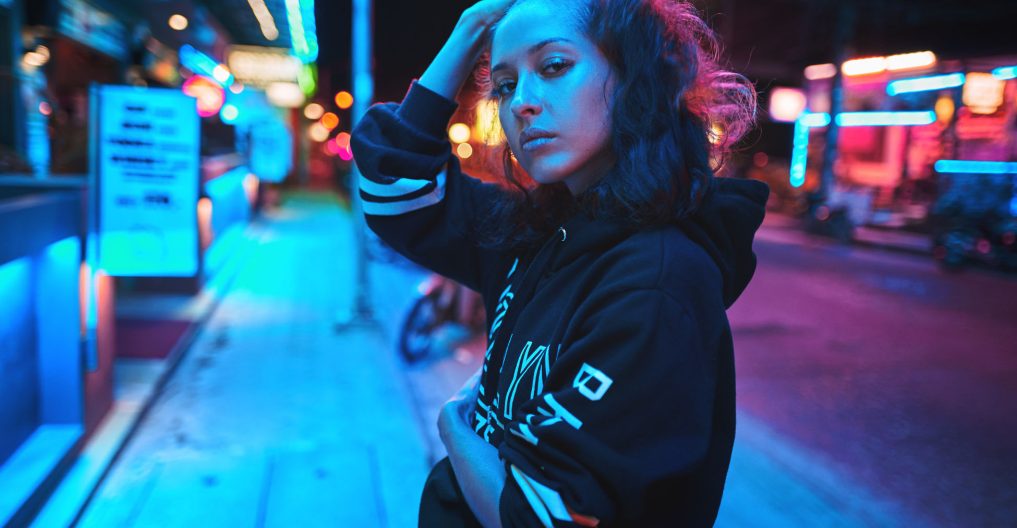 Neon close up portrait of young woman wear hoodie. night city street shot Neon close up portrait of young beautiful woman wear hoodie. night city street shot